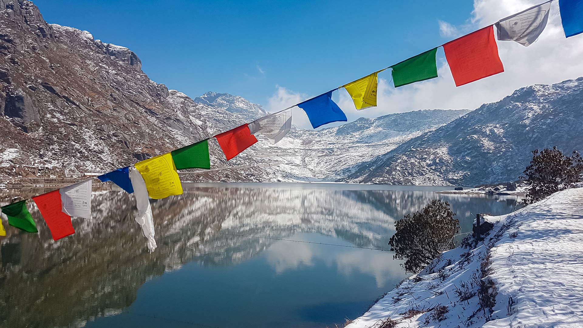 Prayer flags above a frozen Himalayan lake